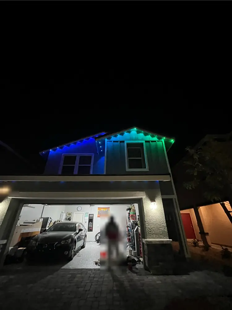 Permanent RGB eave lighting in blue and green on a two-story home, Las Vegas