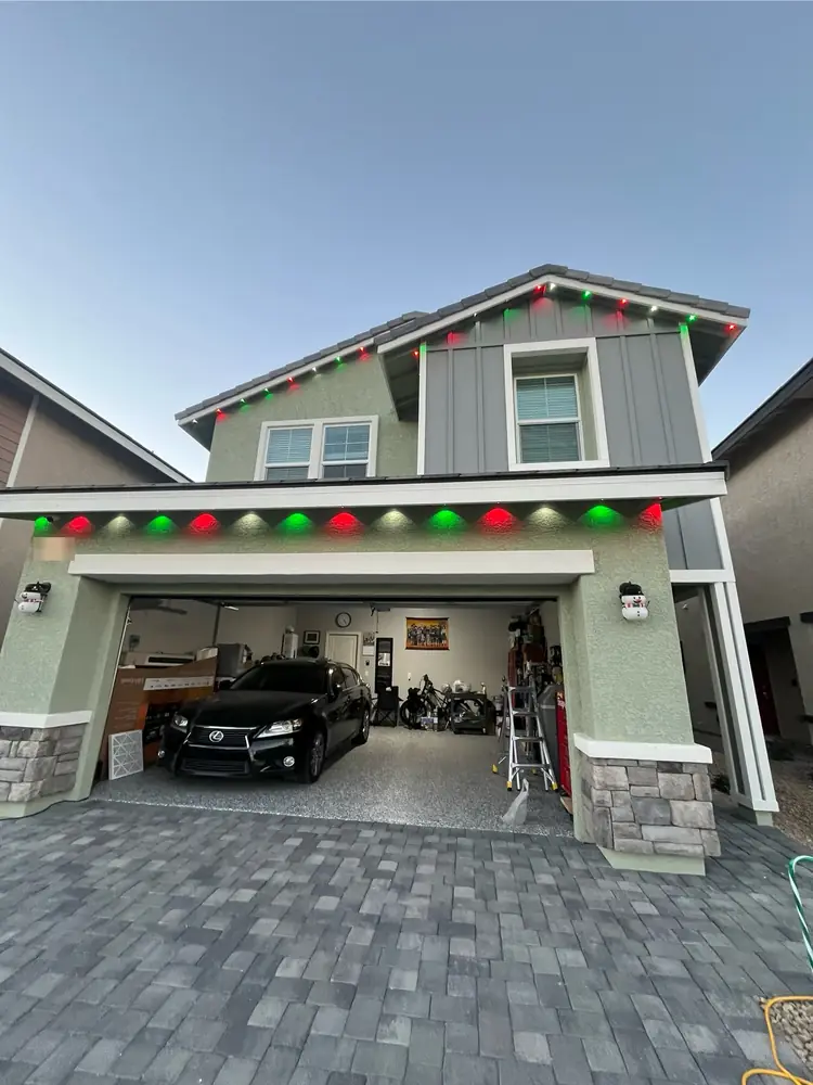 Red, green and white eave lights at dusk on a two-story home, Las Vegas